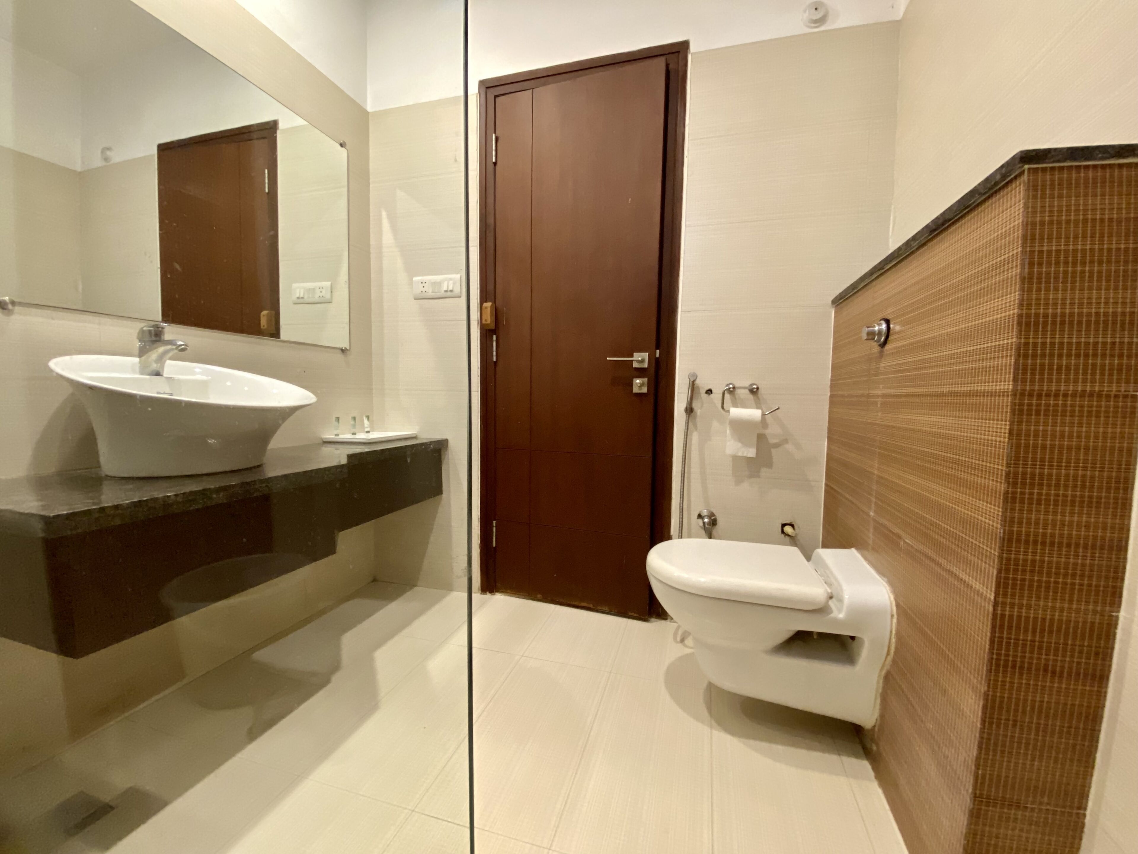 A bathroom with a sink, toilet, and shower area.