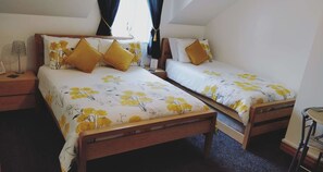 A double room with two single beds, each with floral bedding and matching pillows. - Boutique Country House BandB (Crumlin)