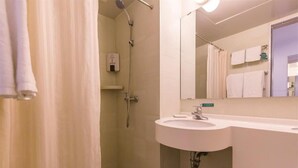A bathroom with a shower, sink, and mirror. - JIN Jiang INN Pingan Street (Shijiazhuang)