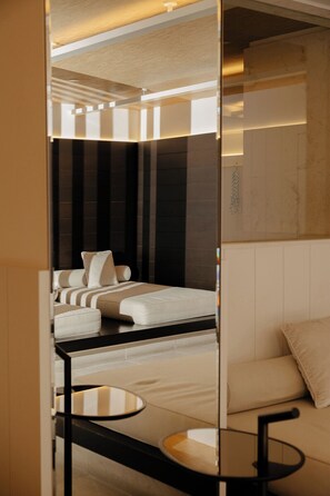 A modern hotel room with a bed, a sofa, and a small table. - Four Seasons Hotel Montreal (Montreal)