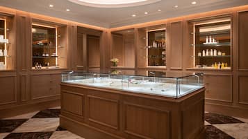 Experience the elegant lobby, featuring a stunning display case and beautifully appointed wooden paneling and marble flooring.