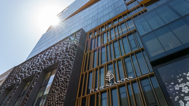 A modern building with a glass facade and the text "FOUR SEASONS" on the side. - Four Seasons Hotel Montreal (Montreal)