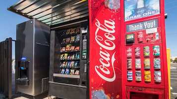 A vending machine with a Coca-Cola logo and a Dasani water dispenser.
