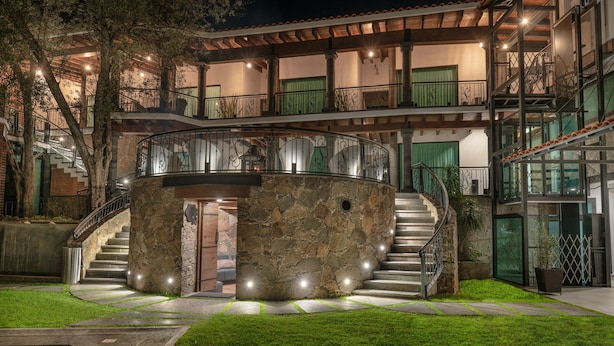A multi-story building with a circular stone structure, a staircase, and a pool. - Matian Hotel Boutique (Tequisquiapan)