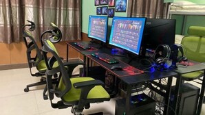 A gaming setup with two monitors, a keyboard, and a mouse on a desk.