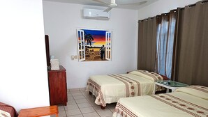 A hotel room with two beds, a desk, a chair, a window with curtains, and a painting on the wall. - Hotel Lulu (Tondoroque)