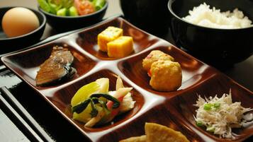 A traditional Japanese meal with various dishes arranged on a rectangular tray.