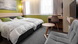 A hotel room with two beds, a desk, a chair, a television, and a large window with curtains. - Fujieda Park in Hotel (Fujieda)
