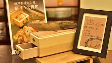 A wooden chest with a knife and a framed menu.