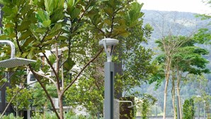 A landscaped pathway with a modern lamppost, surrounded by lush greenery and a view of distant mountains. - 7Stonez Suites Midhills Genting Highlands (Genting Highlands)