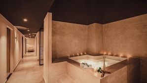 A modern spa area with a large, rectangular hot tub, a wooden bench, and a small plant. - Nesta Valley Dalat Hotel - Golf Valley Hotel (Xuan Huong - Da Lat)