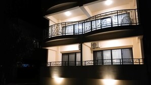 Un immeuble à plusieurs étages doté de balcons et de climatiseurs.