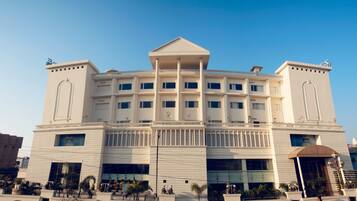 A large, multi-story building with a symmetrical facade, large windows, and a central entrance.