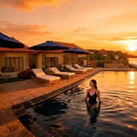 A pool area with lounge chairs and umbrellas, surrounded by buildings.
