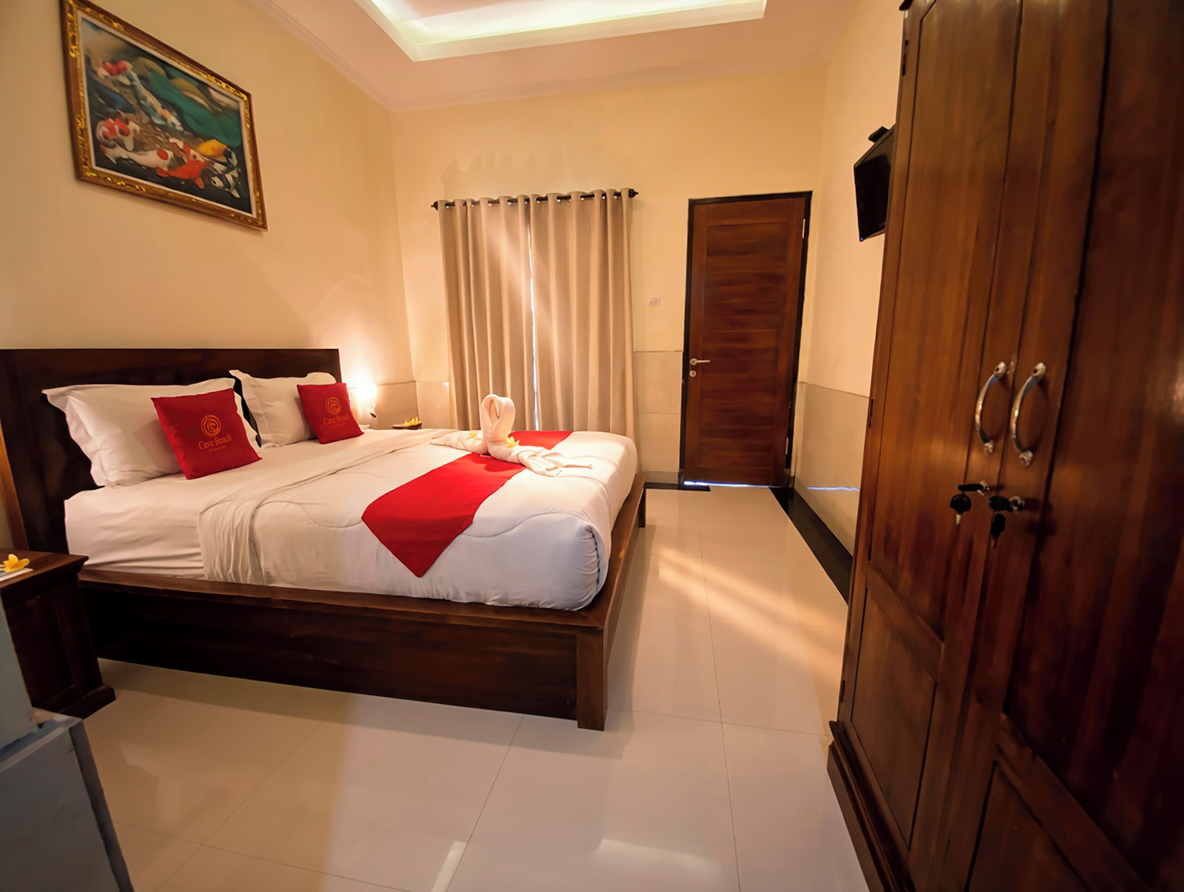 A hotel room with a bed, a wardrobe, a painting on the wall, and a window with curtains.