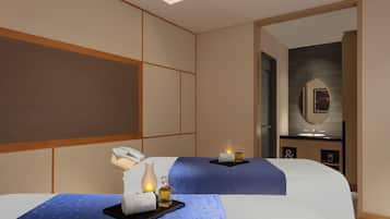 Two beds with clean bedding, a table, and a bathroom with a mirror and sink.