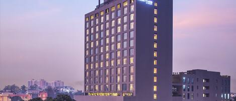 A modern hotel with a prominent 'Courtyard' sign, multiple floors, and a flat roof design.