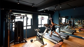 A gym with treadmills, exercise bikes, and weight machines. - The Zuri Pekanbaru (Pekanbaru)