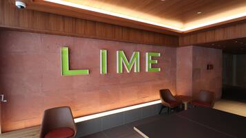A conference room with a large table and four chairs. The word "LIME" is prominently displayed on the wall.