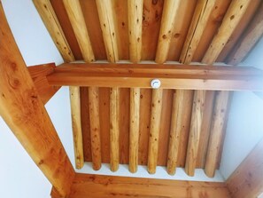 A wooden ceiling structure with a central beam and multiple slats. - Stay Line (Gyeongju)