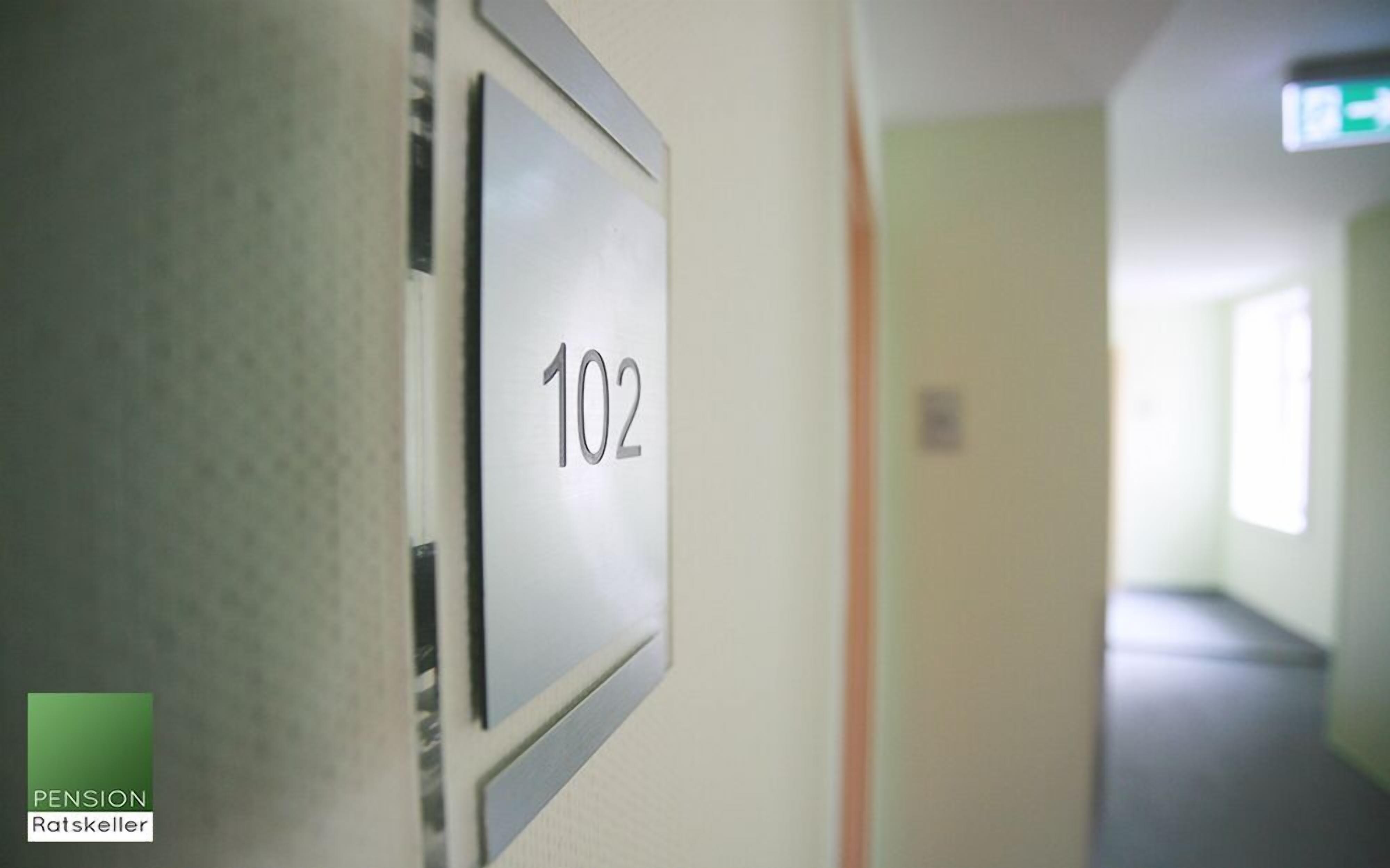 A hallway with a door labeled '102'.