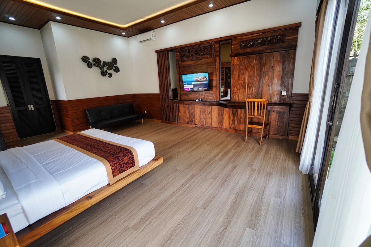 Une chambre d’hôtel équipée d’un lit, d’un bureau, d’une chaise et d’un téléviseur.