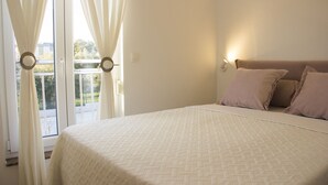A bedroom with a large bed, a window with curtains, and a wall-mounted light. - Apartments Karla (Bibinje)
