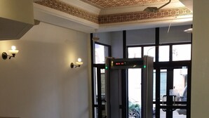 A lobby with a marble floor, a staircase, and a patterned ceiling. - Sahara Line Hotel (Laayoune)