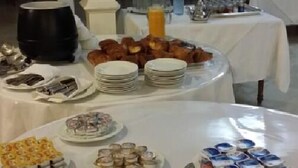 A buffet setup with various food items and utensils. - Sahara Line Hotel (Laayoune)