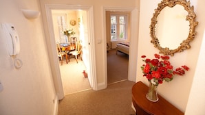 A hallway with a dining area, a bedroom, and a bathroom. - Abbey Court (Sherborne)