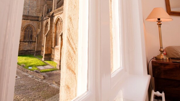A room with a view of a historic building through a window. - Abbey Court (Sherborne)