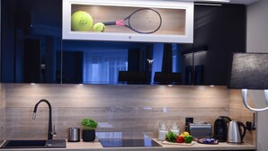 A modern kitchen with a built-in microwave, a coffee maker, and a toaster. - AGA Tenis Apartments by Radwanska (Kraków)