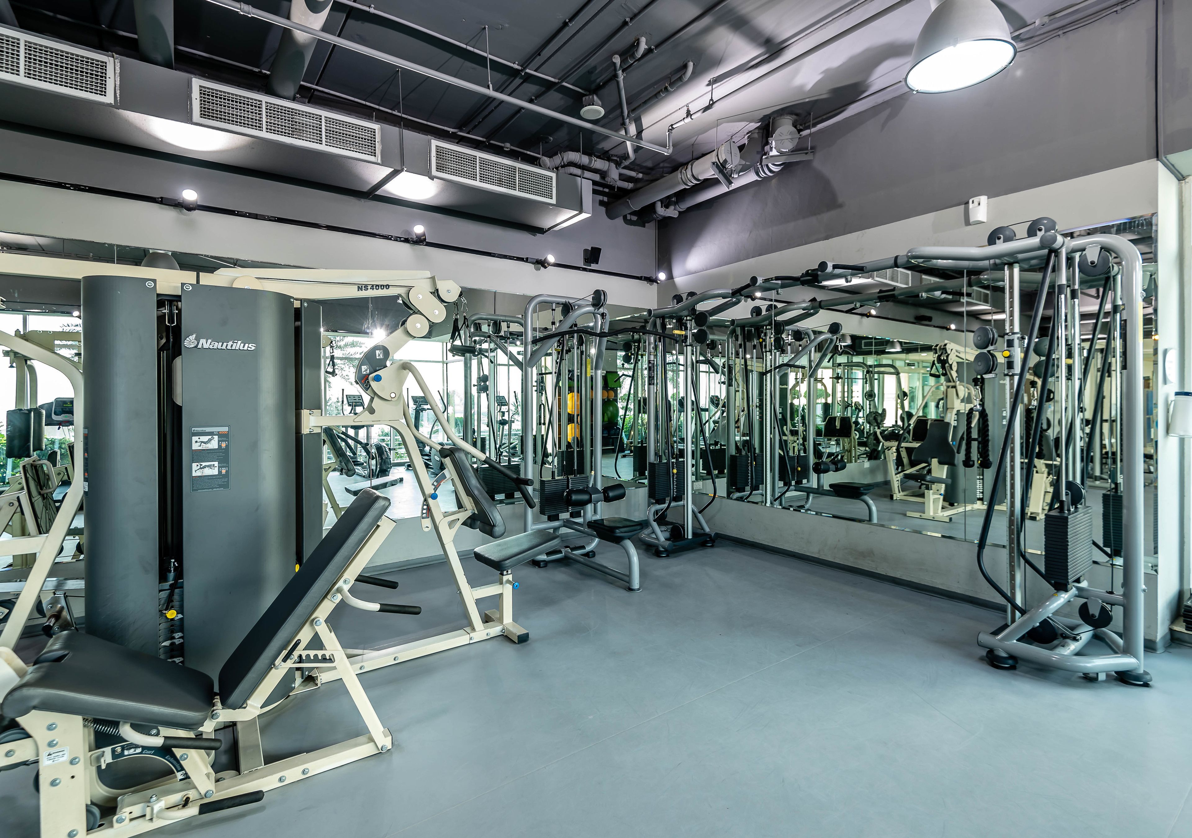 A gym with Nautilus equipment, mirrors, and a clean, modern design.