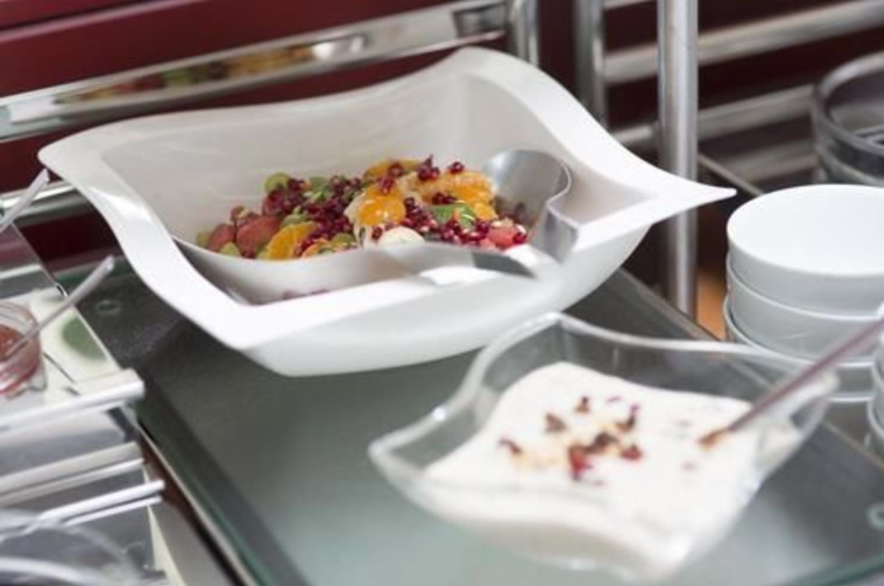 A white bowl with a salad on a tray.