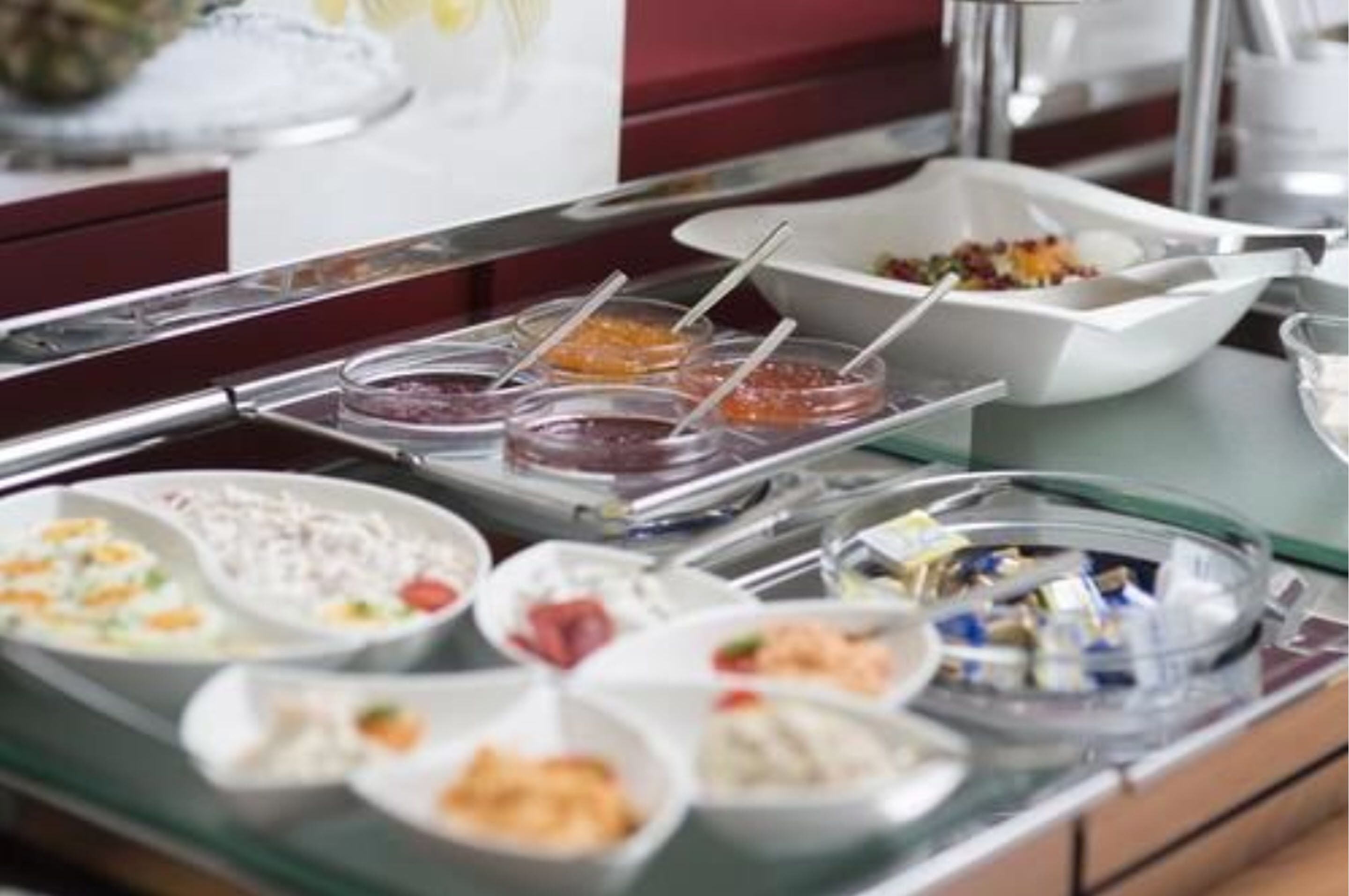 A buffet with various dishes and condiments.