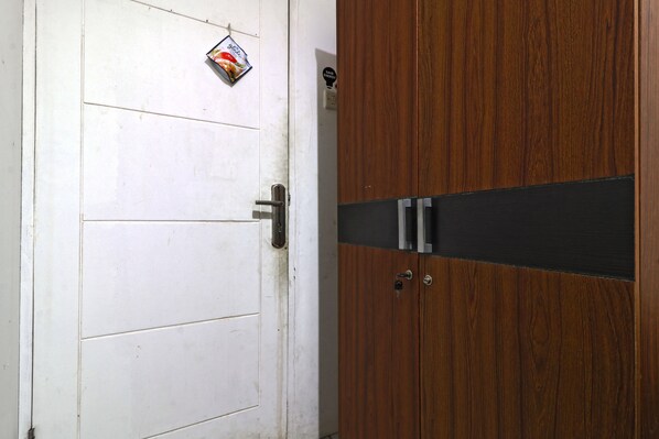 A white door with a metal handle and a small decorative item above it.