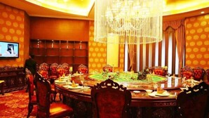 A formal dining room with a round table, ornate chairs, and a chandelier. - Tiangui Zhongzhou International Hotel (Neixiang)