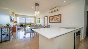 Roble Sabana 105 - Luxury Apartment | Living area | 60-inch flat-screen TV with cable channels, TV - Reserva Conchal Resort - Roble Sabana Complex (Cabo Velas)