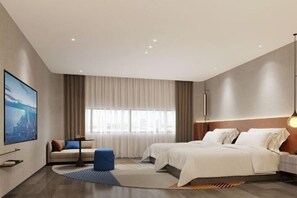 A modern hotel room with a large bed, a sofa, a TV, and a large window with curtains. - Novotel Nantong Center (Nantong)