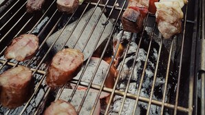 A grill with various meats and vegetables being cooked. - Novotel Nantong Center (Nantong)