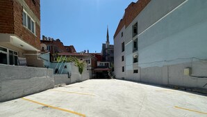 A parking area with a clear view of a church spire in the distance. - BALKAN PALACE EDIRNE (Edirne)