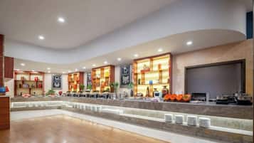 A hotel lobby with a curved ceiling, a reception desk, and a seating area.