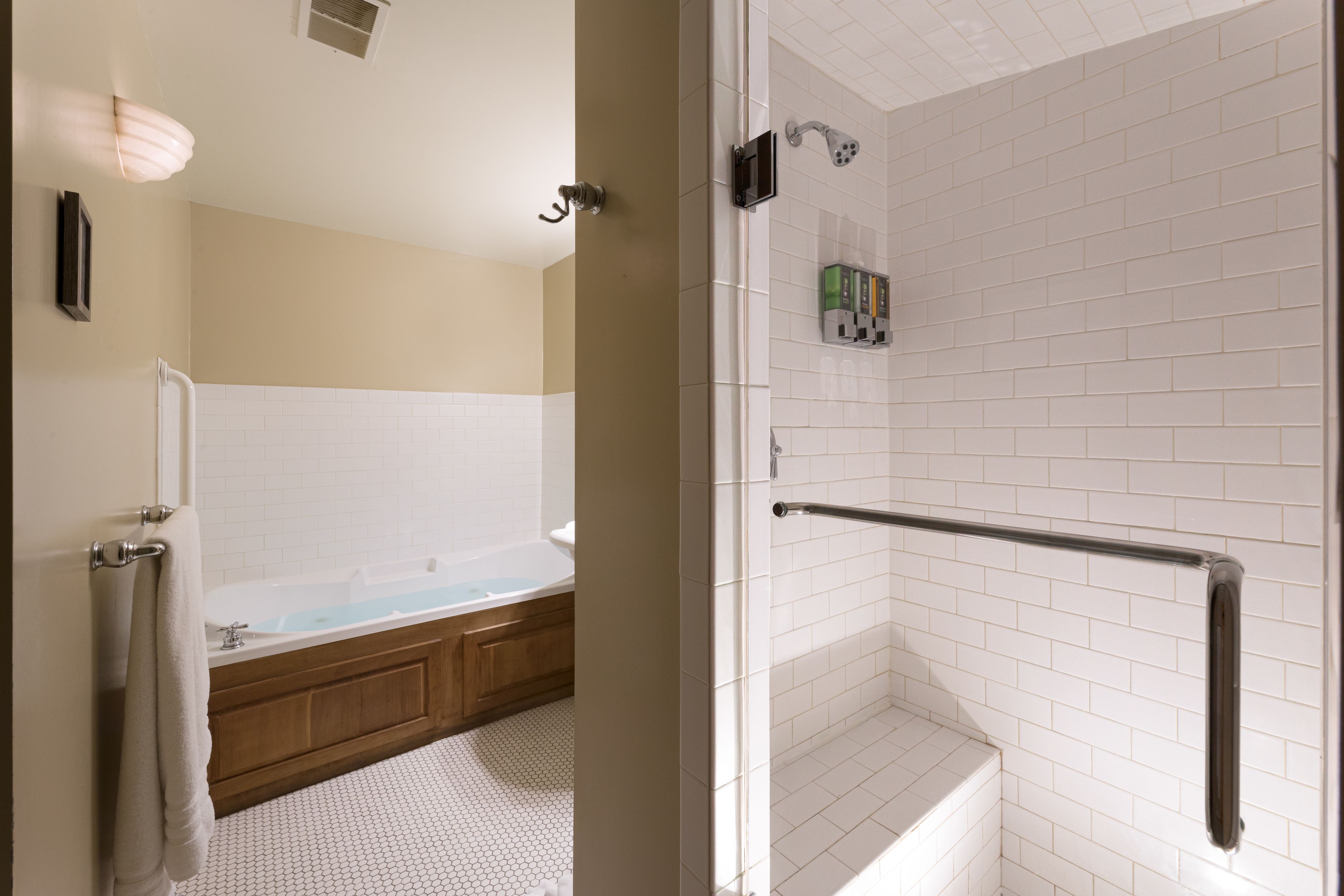 A modern bathroom with a glass shower enclosure, a bathtub, and a toilet.