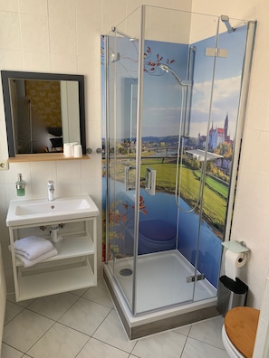 Enjoy a refreshing shower with a scenic view from the glass-enclosed shower area.
