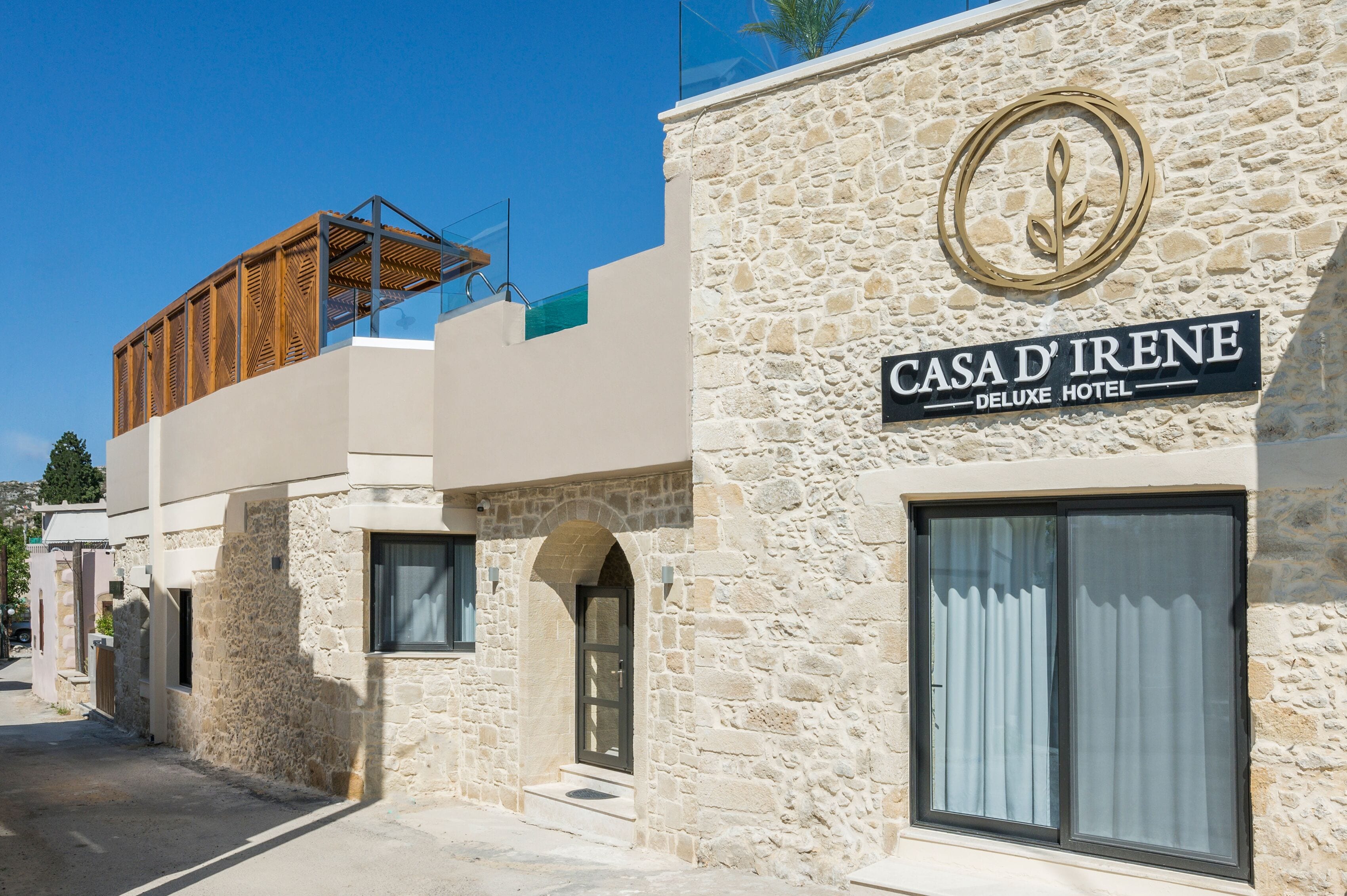 A stone building with a sign reading "Casa d'Irene Deluxe Hotel".