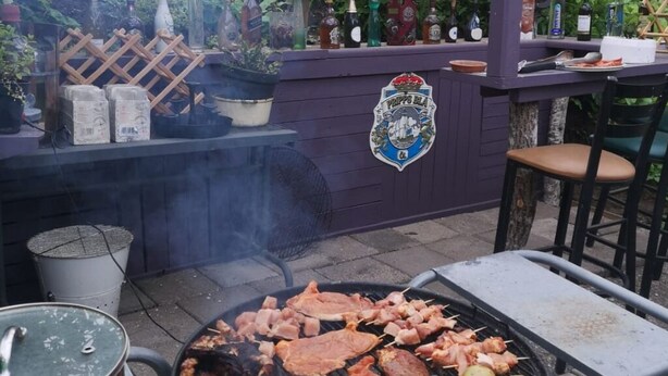 An outdoor barbecue area with a grill, bar, and seating. - Stop at The Cross (Dalsjöfors)