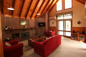 Deluxe Villa | Living room | -40-inch Smart TV with satellite channels, TV, fireplace - The Lodges (Halls Gap)