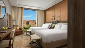 A modern hotel room with two beds, a desk, and a view of a canyon. - Hoodoo Moab, Curio Collection by Hilton (Moab)