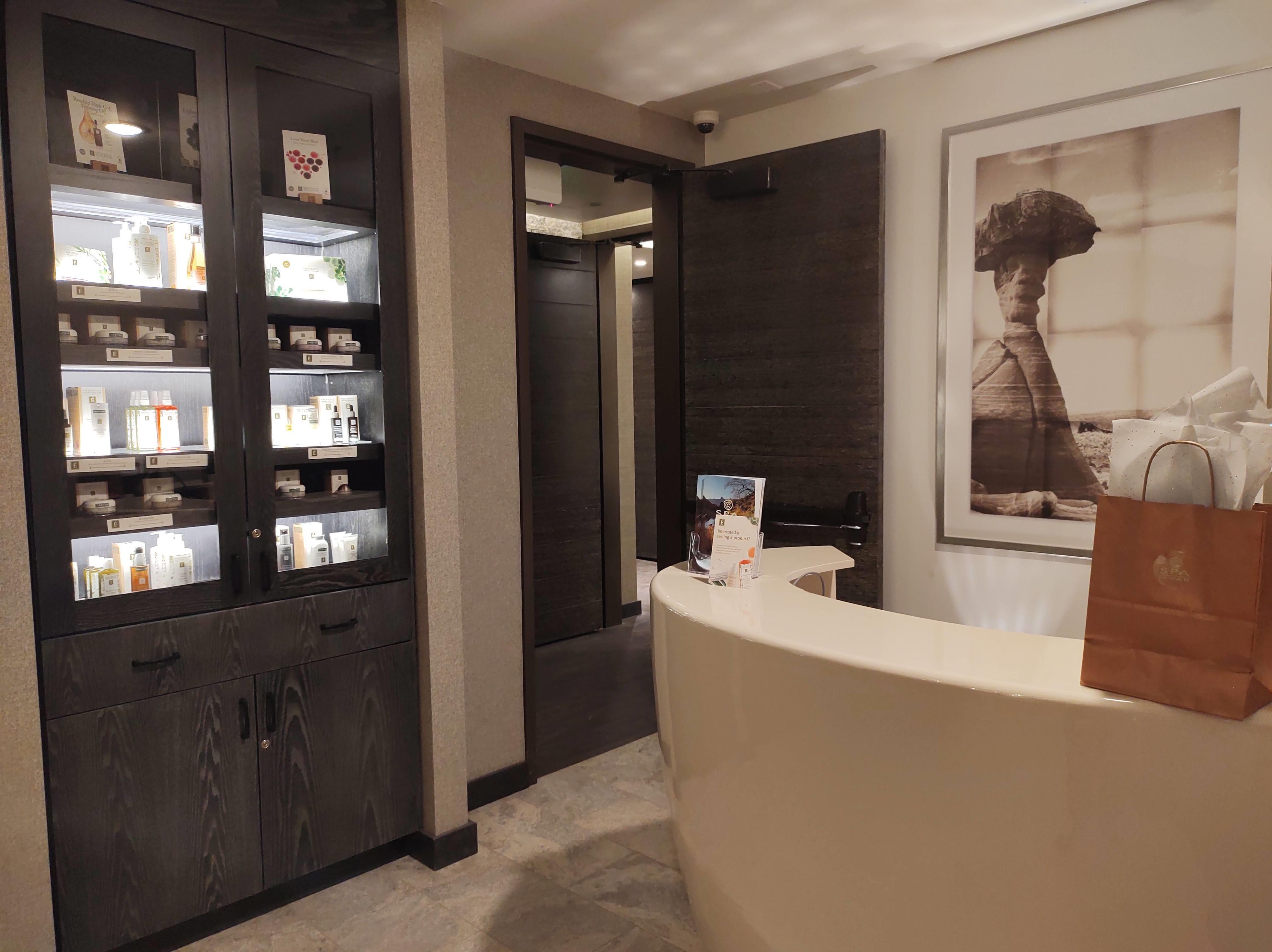 A reception area with a counter, a display case with products, and a framed picture on the wall.