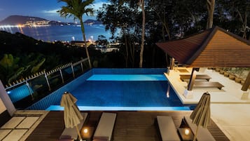 Relax by the serene pool surrounded by lush greenery and enjoy stunning views of the coastline.